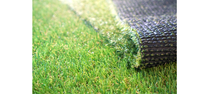 rolled artificial turf on top of another square of artificial turf