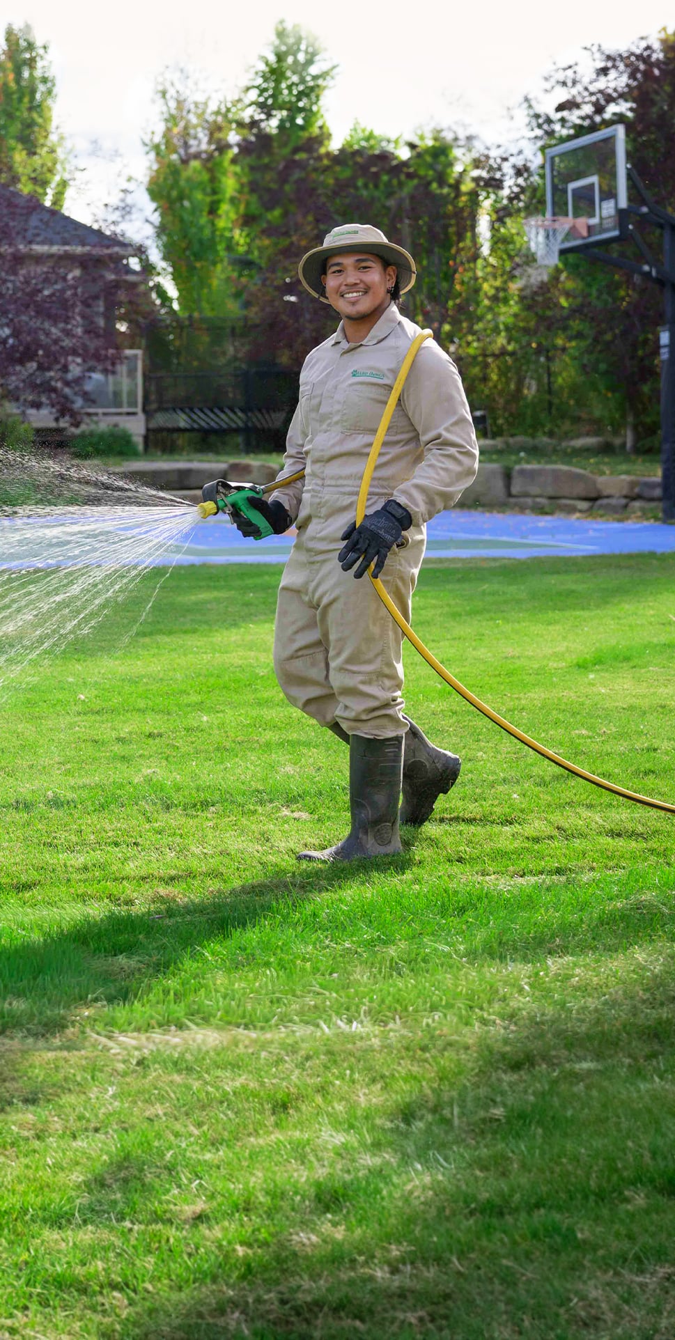 Lawn Specialist Unloading Hose From Truck
